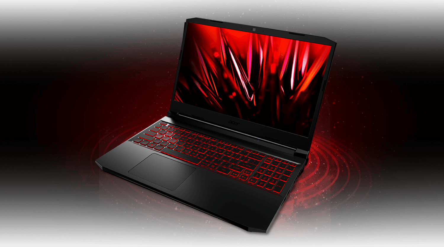 Notebook nitro 5 visto de frente e acima, sobre onda circular vermelha. Na tela, imagem de cristais vermelhos.